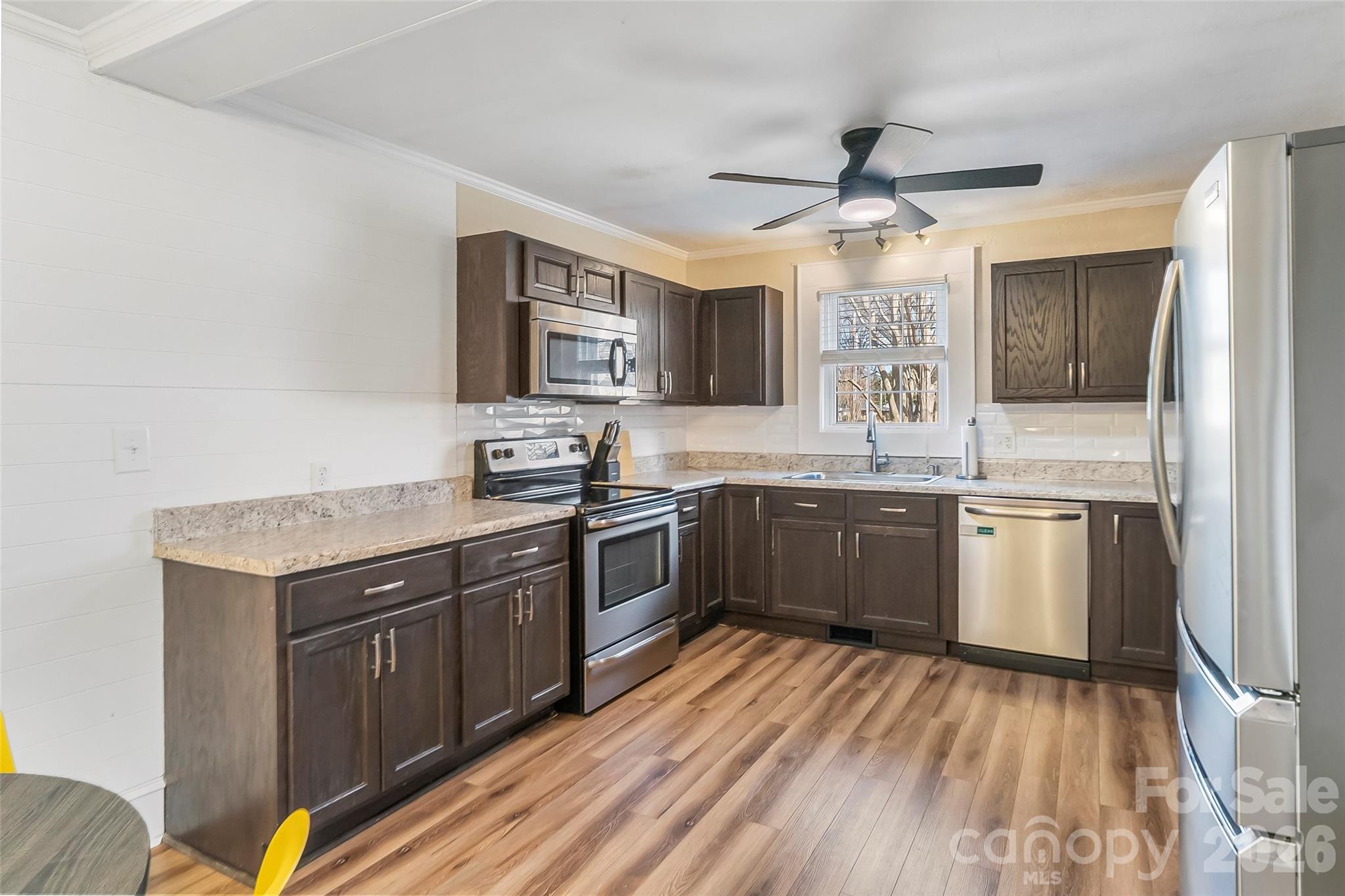 1072 5th Street Northeast Hickory, NC 28601 - Photo 5 of 33 a kitchen with a sink stove and refrigerator