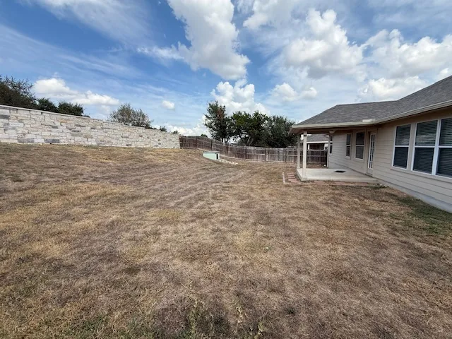 a view of a house with a backyard