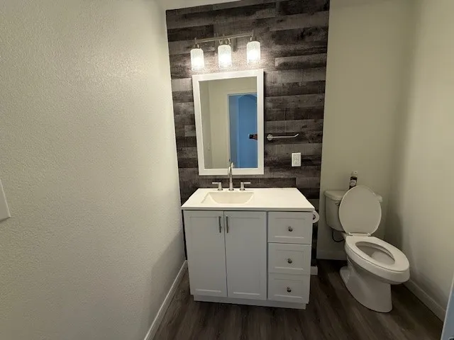 a view of bathroom with a toilet sink and mirror