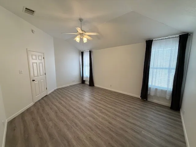 wooden floor in an empty room with a window