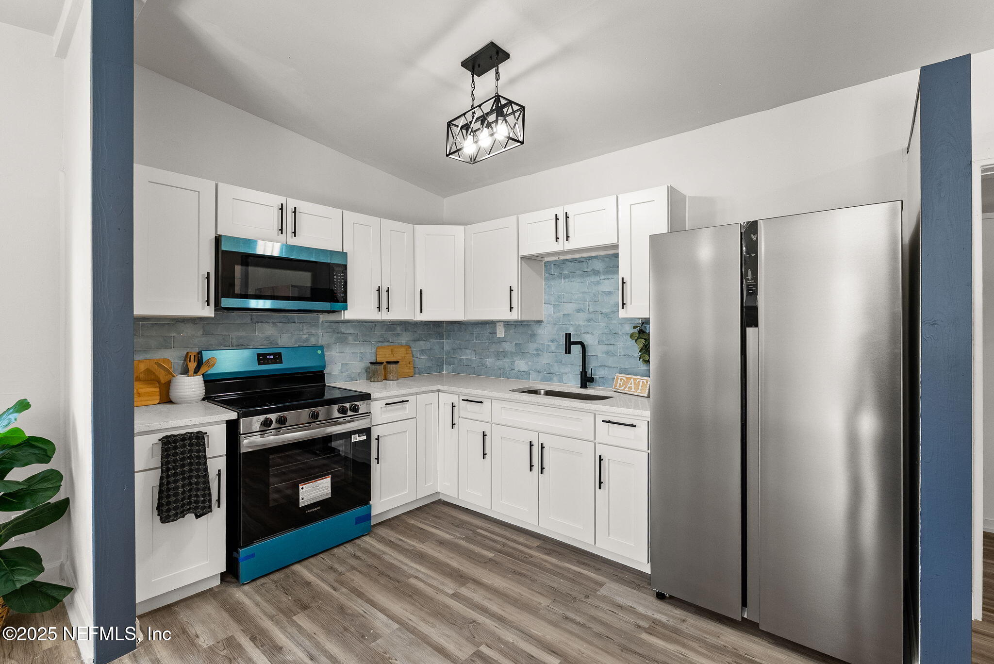 a kitchen with stainless steel appliances a stove a sink and a refrigerator