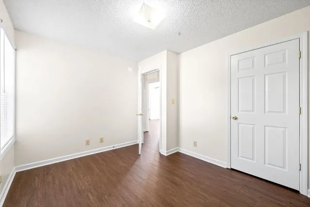 an empty room with wooden floor