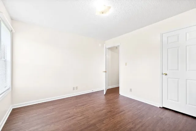 an empty room with wooden floor