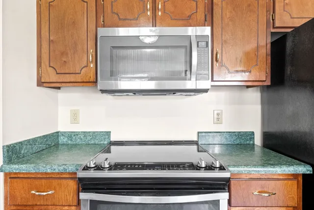 a stove top oven sitting inside of a kitchen