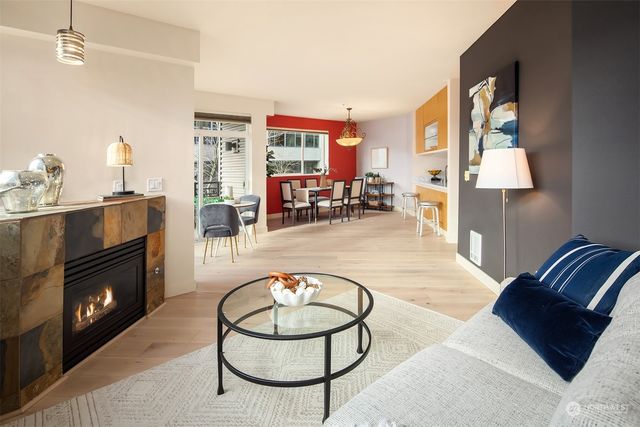 a living room with furniture a rug and a fireplace