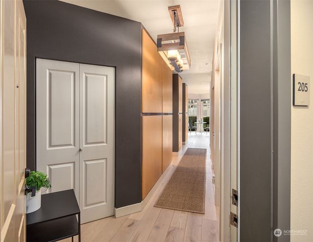 a view of a hallway with wooden floor and staircase