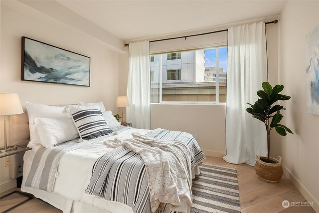 a bedroom with a bed and a window