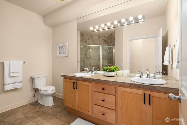 a bathroom with a toilet sink and mirror