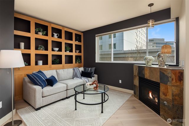 a living room with furniture a floor to ceiling window and floor to ceiling window
