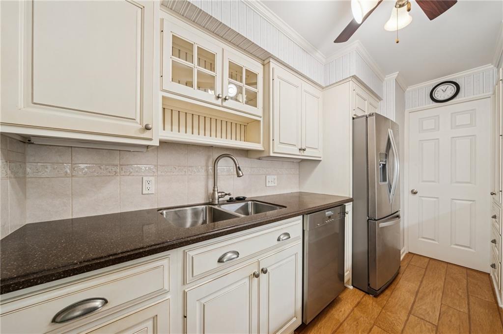 53 Highland Road, Unit 403404 Bethel Park, PA 15102 - Photo 15 of 33 a kitchen with stainless steel appliances granite countertop a sink and a refrigerator