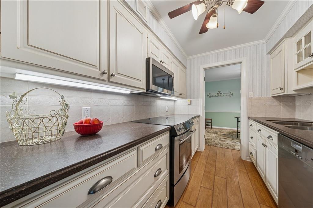 53 Highland Road, Unit 403404 Bethel Park, PA 15102 - Photo 16 of 33 a kitchen with stainless steel appliances granite countertop a sink and cabinets