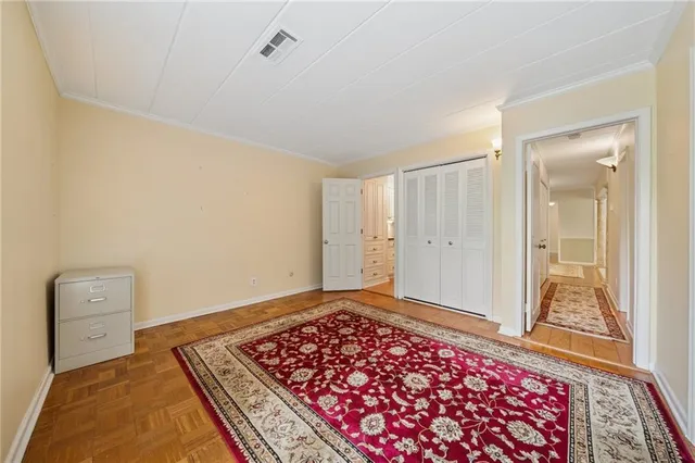 a bedroom with furniture and a rug
