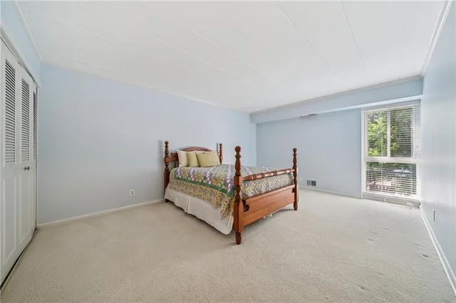 a bathroom with a sink a toilet a mirror a bathtub and shower