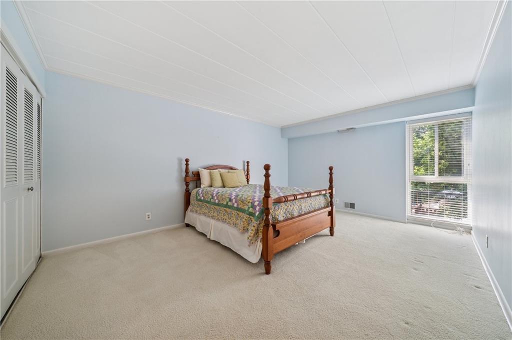 53 Highland Road, Unit 403404 Bethel Park, PA 15102 - Photo 23 of 33 a bed room with a bed and a lamp