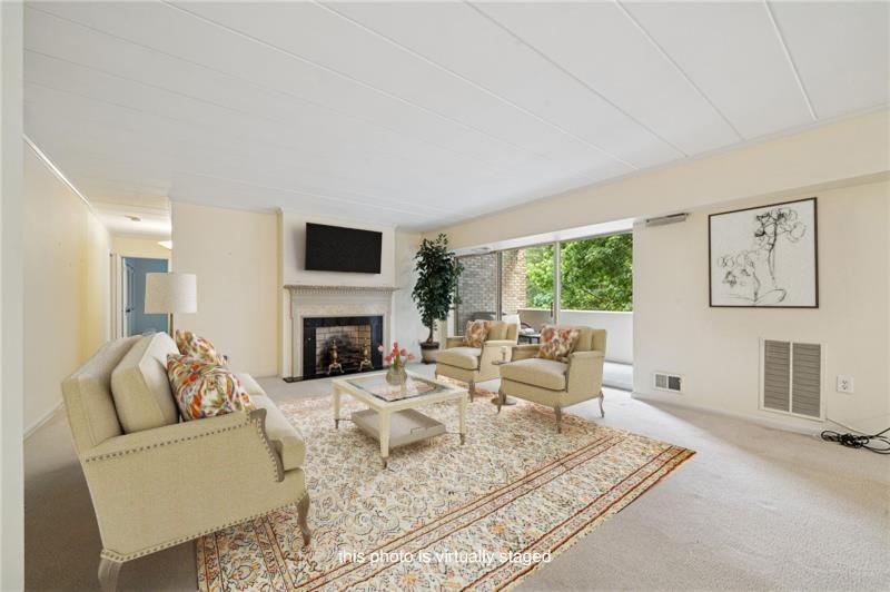 53 Highland Road, Unit 403404 Bethel Park, PA 15102 - Photo 4 of 33 a living room with furniture a fireplace and a flat screen tv