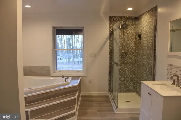 a bathroom with a shower and a sink