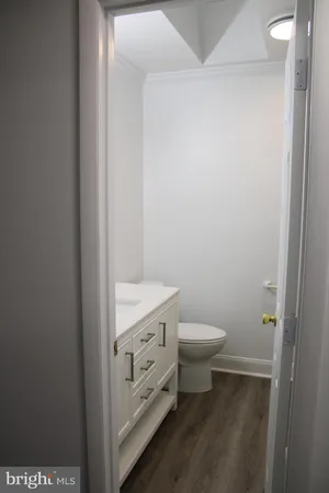 a white toilet and tub sitting next to a bathroom sink