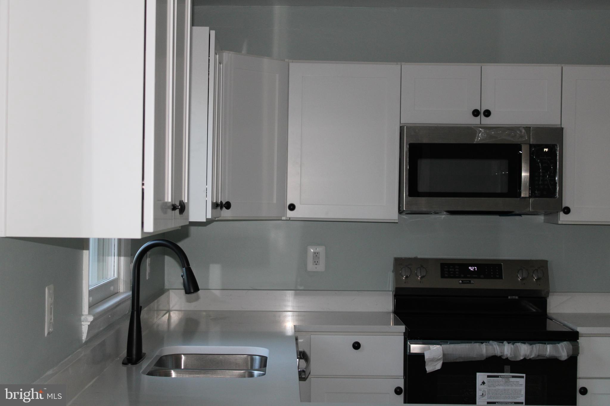 28 Henry Way Linden, VA 22642 - Photo 3 of 85 a kitchen with stainless steel appliances granite countertop a sink a microwave and cabinets