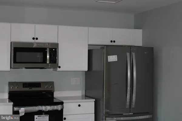 a kitchen with a microwave and cabinets