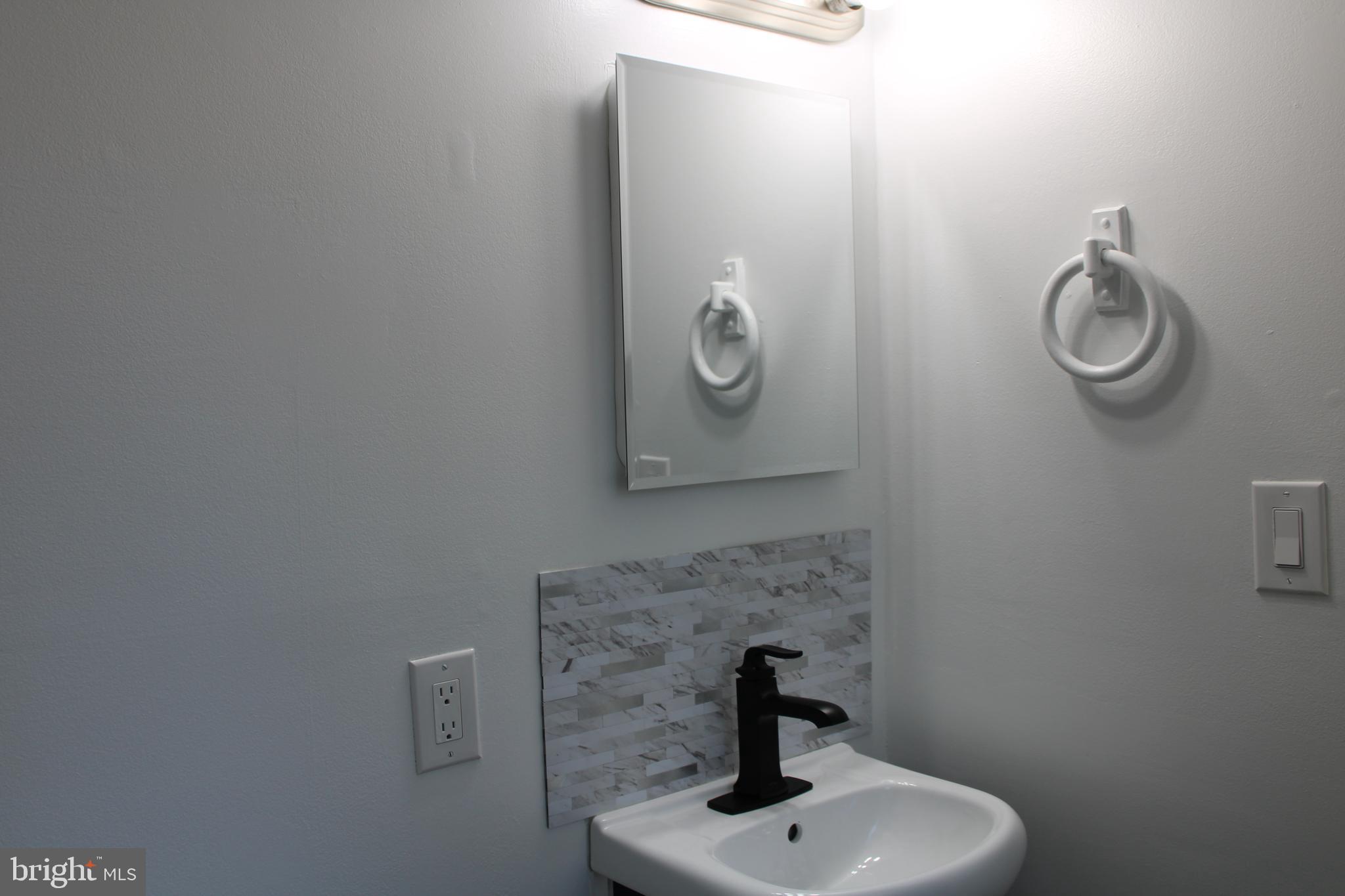 28 Henry Way Linden, VA 22642 - Photo 45 of 85 a bathroom with a sink and mirror