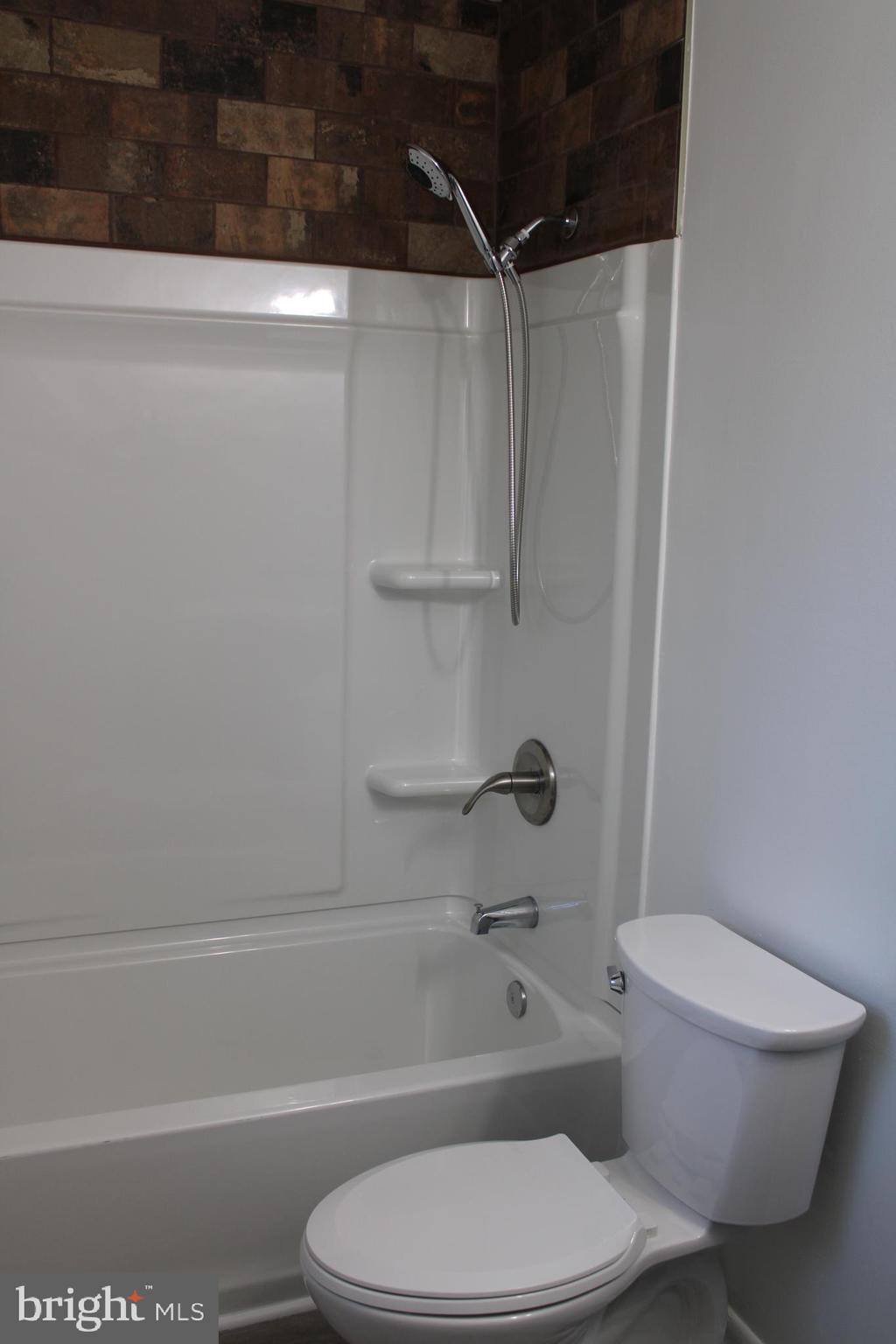 28 Henry Way Linden, VA 22642 - Photo 47 of 85 a white toilet and tub sitting next to a bathroom sink
