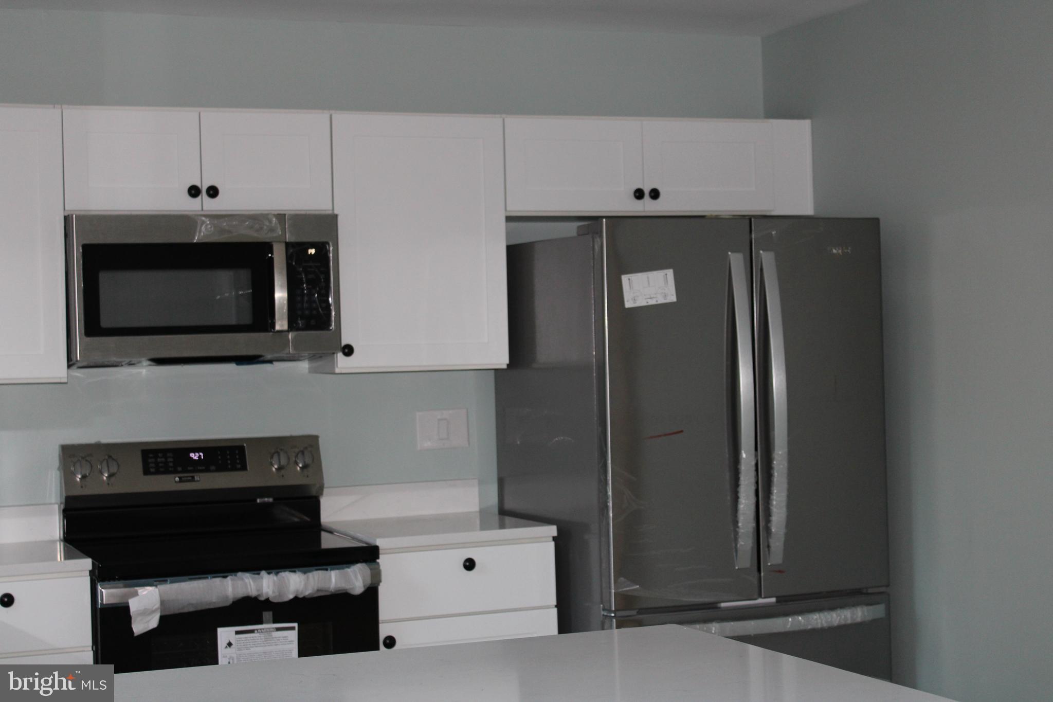 28 Henry Way Linden, VA 22642 - Photo 6 of 85 a kitchen with stainless steel appliances a refrigerator a stove and white cabinets