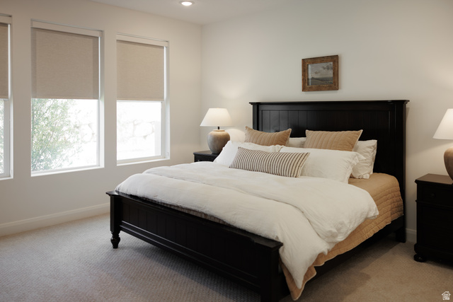 629 Spring Lily Drive St. George, UT 84790 - Photo 11 of 50 Bedroom featuring a dark wood bed frame, three large windows with roller shades, recessed lighting, and carpet flooring