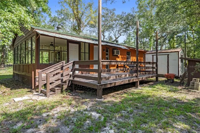 a view of a house with a yard and wooden fence