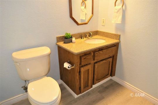 1122 North Inyo Street Ridgecrest, CA 93555 - Photo 28 of 34 a bathroom with a toilet sink and mirror