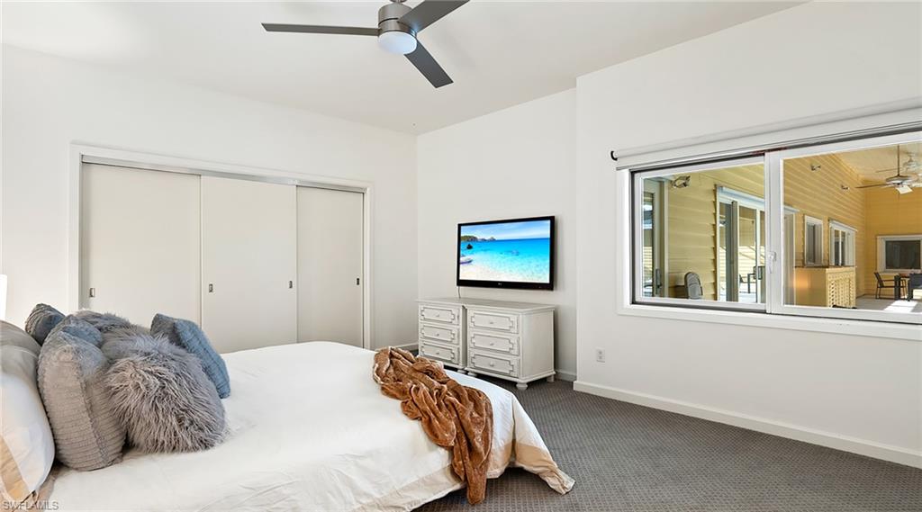 586 Yucca Road Naples, FL 34102 - Photo 15 of 26 Carpeted bedroom with a closet and a ceiling fan