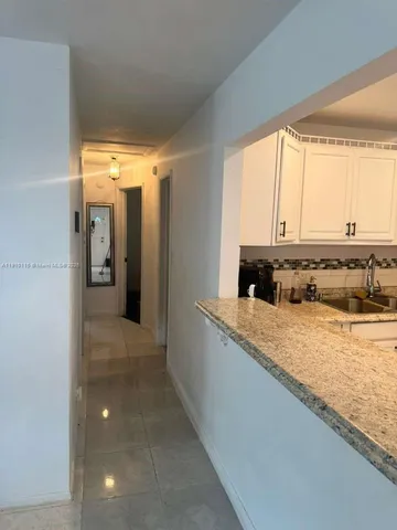 a kitchen with stainless steel appliances granite countertop a sink and a stove