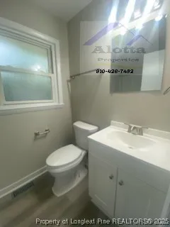 a bathroom with a sink toilet and mirror