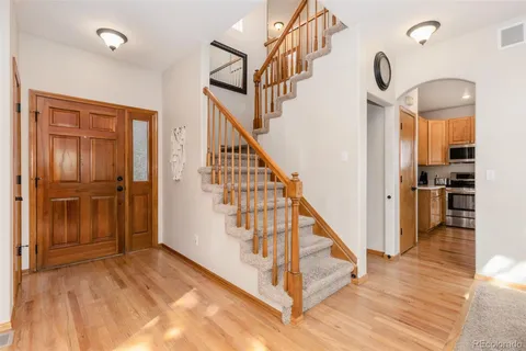a view of entryway and hall with wooden floor