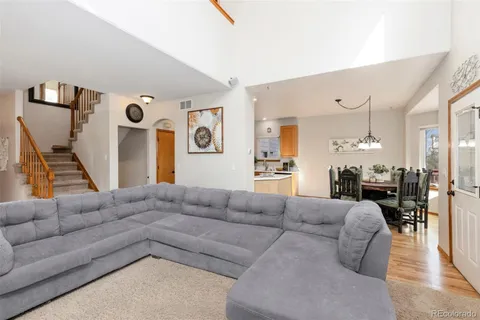 a living room with furniture and wooden floor