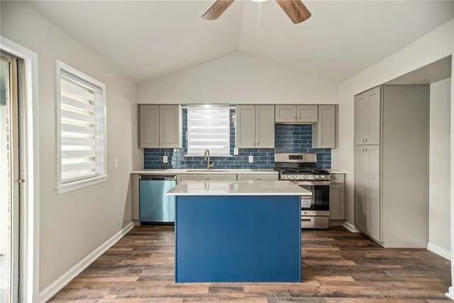 a kitchen with a sink stove and cabinets