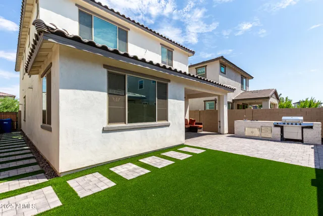 a view of a house with a yard and sitting area