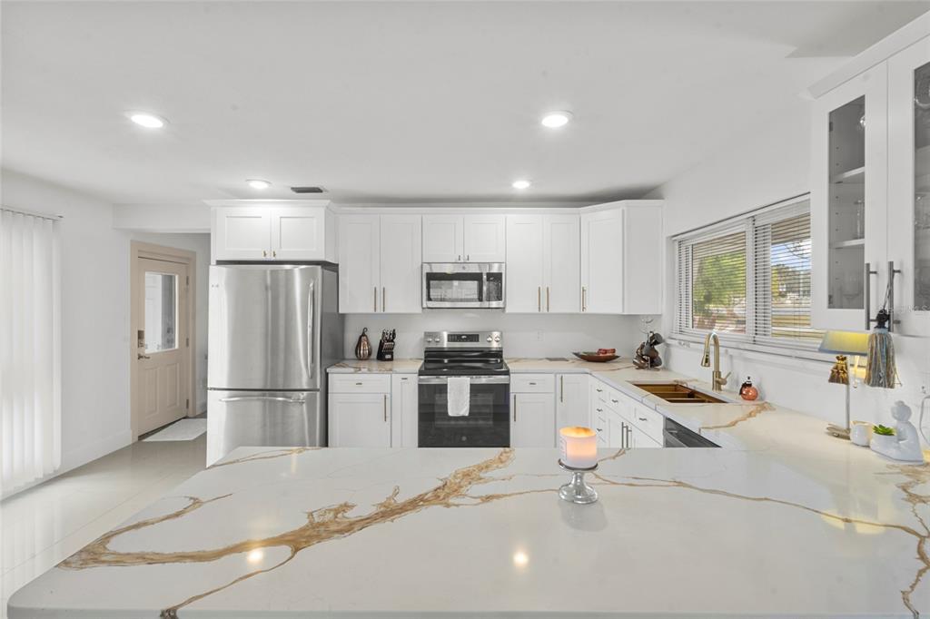 7230 Shepherd Street Sarasota, FL 34243 - Photo 12 of 30 a kitchen with refrigerator and cabinets