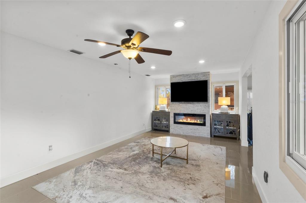 7230 Shepherd Street Sarasota, FL 34243 - Photo 13 of 30 a living room with furniture and a flat screen tv