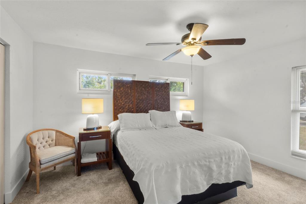 7230 Shepherd Street Sarasota, FL 34243 - Photo 14 of 30 a bedroom with a bed and a chandelier