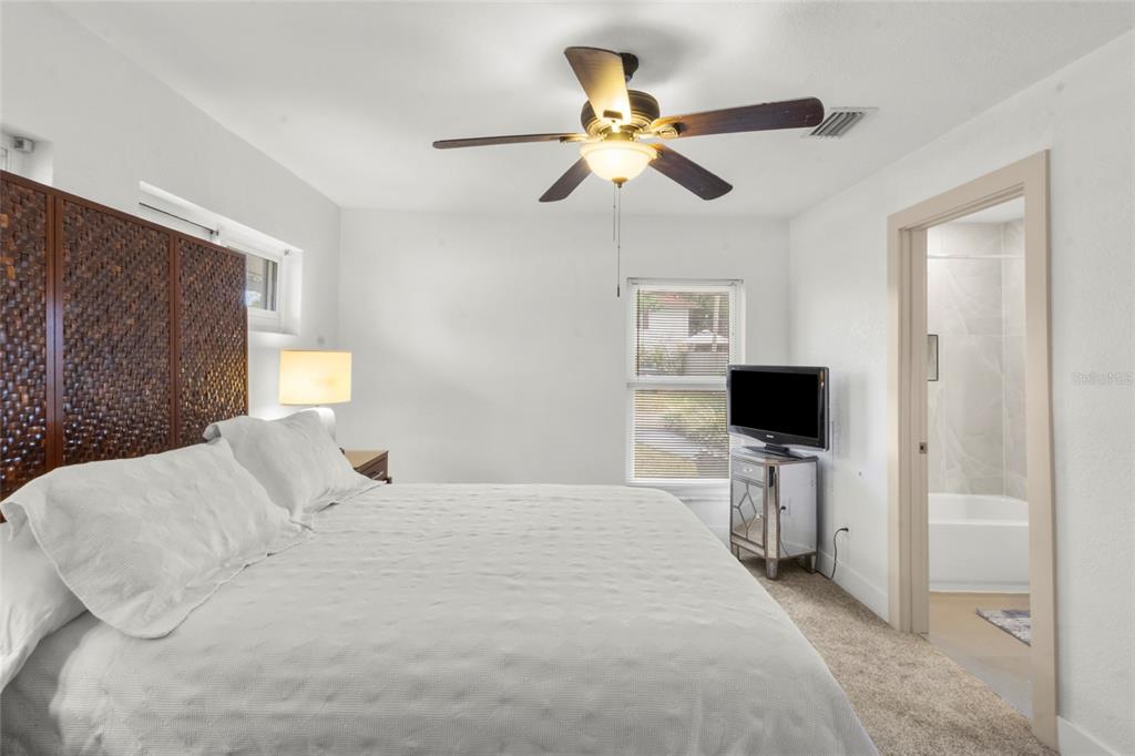 7230 Shepherd Street Sarasota, FL 34243 - Photo 15 of 30 a bedroom with a bed and a flat screen tv