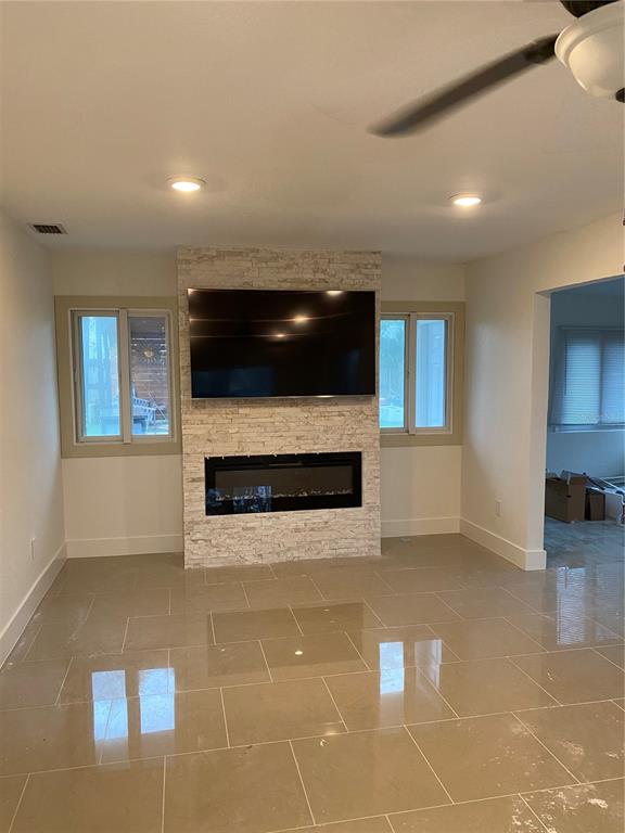 7230 Shepherd Street Sarasota, FL 34243 - Photo 16 of 38 a living room with a fireplace furniture and a flat screen tv