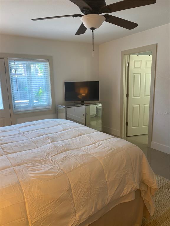 7230 Shepherd Street Sarasota, FL 34243 - Photo 20 of 38 a bedroom with a bed and a flat screen tv