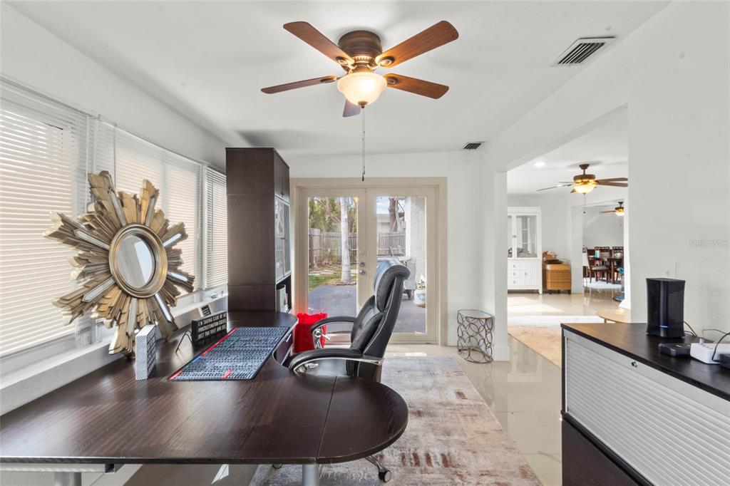 7230 Shepherd Street Sarasota, FL 34243 - Photo 20 of 30 a living room with furniture a flat screen tv and a large window