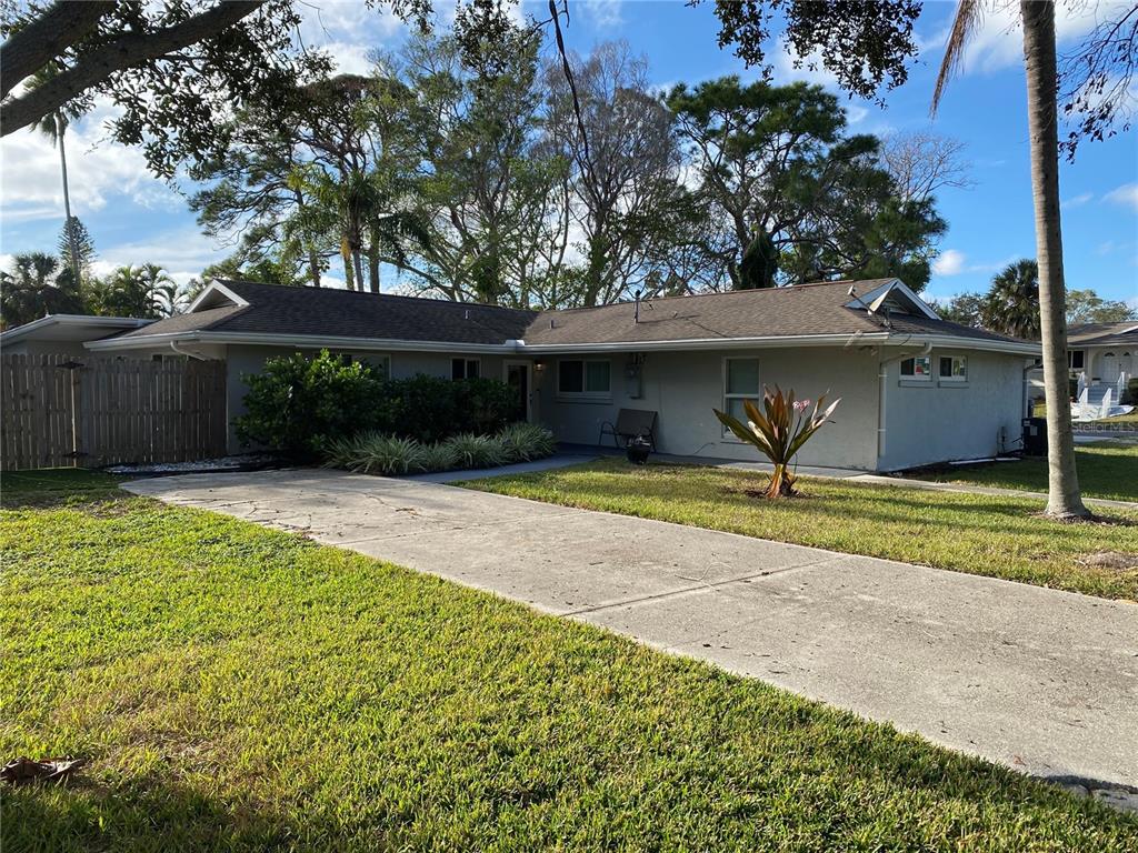 7230 Shepherd Street Sarasota, FL 34243 - Photo 2 of 38 a front view of a house with a yard