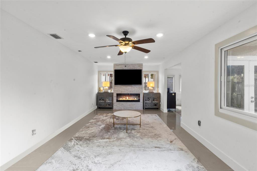 7230 Shepherd Street Sarasota, FL 34243 - Photo 22 of 30 a view of a livingroom with a flat screen tv and a fireplace
