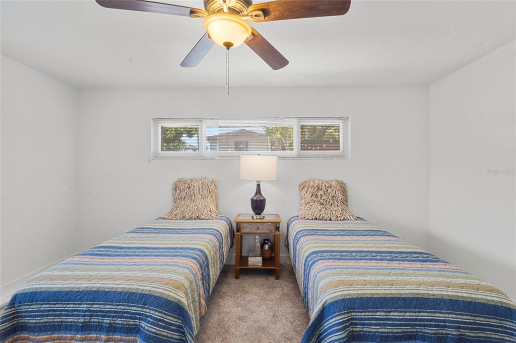 7230 Shepherd Street Sarasota, FL 34243 - Photo 24 of 30 a bedroom with double bed and a lamp