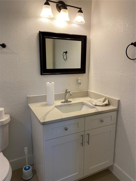 7230 Shepherd Street Sarasota, FL 34243 - Photo 25 of 38 a bathroom with a toilet sink and mirror