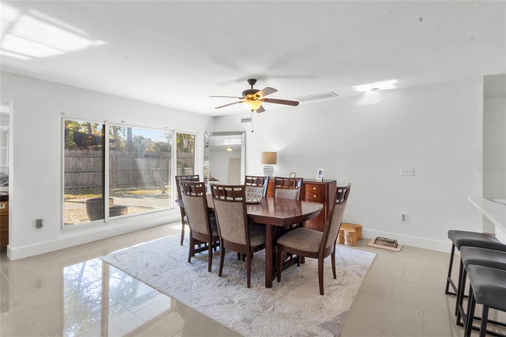 7230 Shepherd Street Sarasota, FL 34243 - Photo 26 of 30 a dining room with furniture a chandelier and wooden floor