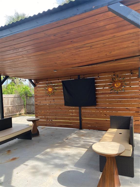 7230 Shepherd Street Sarasota, FL 34243 - Photo 33 of 38 a view of a patio with table and chairs and a barbeque