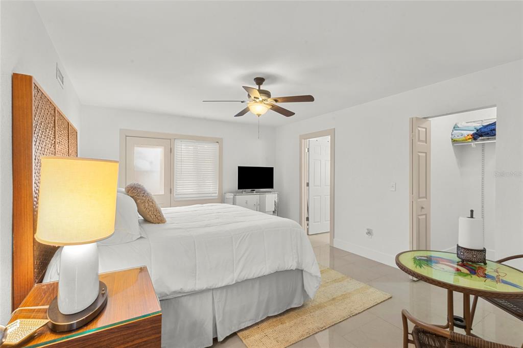 7230 Shepherd Street Sarasota, FL 34243 - Photo 5 of 30 a bedroom with a bed and a chandelier